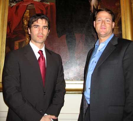 Eduardo Verastegui 9Actor and Producer) with Sean Wolfington (Financier and Producer) at the White House standing beside a painting of George Washington